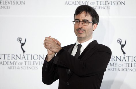 Comedian John Oliver poses for photographers backstage during the 41st International Emmy Awards in New York, November 25, 2013. REUTERS/Car Comedian John Oliver poses for photographers backstage during the 41st International Emmy Awards in New York, November 25, 2013. REUTERS/Car