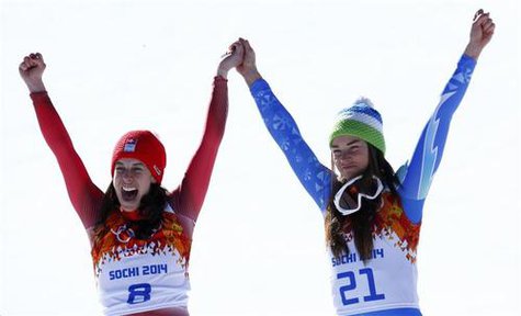 Joint winners Dominique Gisin of Switzerland (L) and Tina Maze of Slovenia celebrate on podium after the women's alpine skiing downhill event during a flower ceremony at the 2014 Sochi Winter Olympics at the Rosa Khutor Alpine CenterFebruary 12, 2014. REUTERS/Ruben Sprich Joint winners Dominique Gisin of Switzerland (L) and Tina Maze of Slovenia celebrate on podium after the women's alpine skiing downhill event during a flower ceremony at the 2014 Sochi Winter Olympics at the Rosa Khutor Alpine CenterFebruary 12, 2014. REUTERS/Ruben Sprich