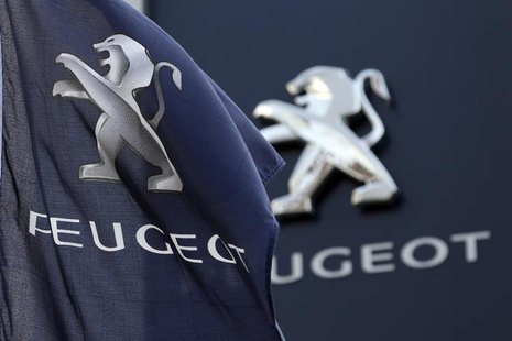 A flag with the company logo is seen outside a Peugeot automobile dealer in Paris December 13, 2013. REUTERS/Charles Platiau A flag with the company logo is seen outside a Peugeot automobile dealer in Paris December 13, 2013. REUTERS/Charles Platiau