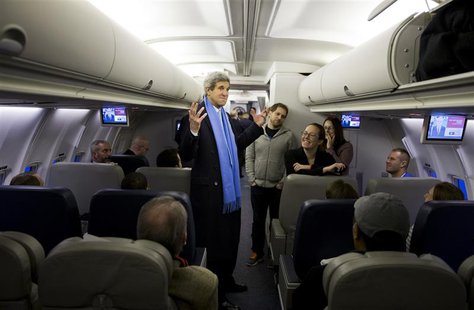 U.S. Secretary of State John Kerry (C) talks with reporters on a plane at Andrews Air Force Base, Maryland before departing for South Korea U.S. Secretary of State John Kerry (C) talks with reporters on a plane at Andrews Air Force Base, Maryland before departing for South Korea