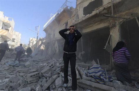 A man reacts at a site hit by what activists said were explosive barrels thrown by forces loyal to Syria's President Bashar al-Assad in the A man reacts at a site hit by what activists said were explosive barrels thrown by forces loyal to Syria's President Bashar al-Assad in the