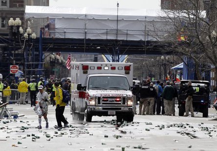 A runner is escorted from the scene after explosions went off at the 117th Boston Marathon in Boston, Massachusetts April 15, 2013. REUTERS/ A runner is escorted from the scene after explosions went off at the 117th Boston Marathon in Boston, Massachusetts April 15, 2013. REUTERS/