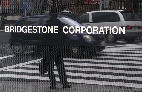 A man is reflected in a signboard of Bridgestone Corp at the company's headquarters in Tokyo February 18, 2011. REUTERS/Toru Hanai A man is reflected in a signboard of Bridgestone Corp at the company's headquarters in Tokyo February 18, 2011. REUTERS/Toru Hanai