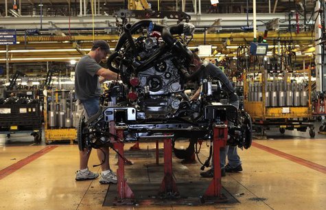 Ford Motor auto assembly workers install an EcoBoost fuel efficient engine in the chassis of a 2014 F-150 pick-up truck at the Dearborn Truc Ford Motor auto assembly workers install an EcoBoost fuel efficient engine in the chassis of a 2014 F-150 pick-up truck at the Dearborn Truc