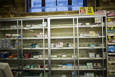 Near empty cigarette shelves are seen at a CVS store in New York February 4, 2014. REUTERS/Eric Thayer Near empty cigarette shelves are seen at a CVS store in New York February 4, 2014. REUTERS/Eric Thayer