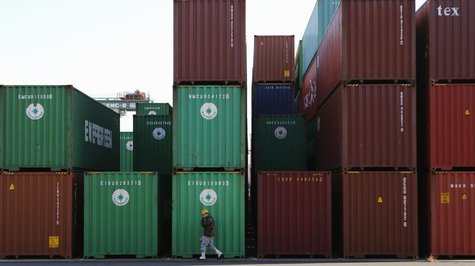 A worker walks in a container area at a port in Tokyo January 27, 2014. REUTERS/Toru Hanai A worker walks in a container area at a port in Tokyo January 27, 2014. REUTERS/Toru Hanai