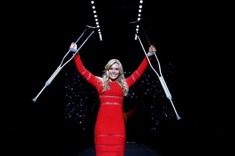 Olympic downhill champion Lindsey Vonn raises her crutches as she presents a creation by Cynthia Rowley for the The Heart Truth Fall 2014 co Olympic downhill champion Lindsey Vonn raises her crutches as she presents a creation by Cynthia Rowley for the The Heart Truth Fall 2014 co