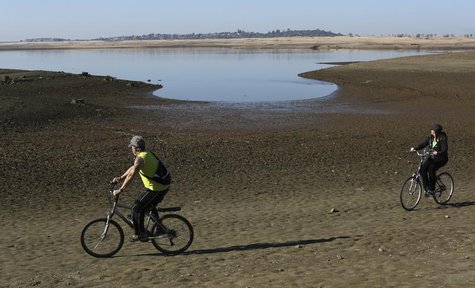 Visitors ride bicycles near the receding waters at Folsom Lake, which is 17 percent of its capacity, in Folsom, California January 22, 2014. Visitors ride bicycles near the receding waters at Folsom Lake, which is 17 percent of its capacity, in Folsom, California January 22, 2014.