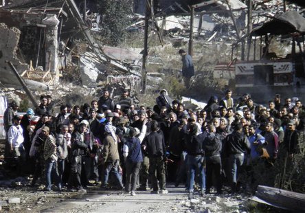 Civilians wait to be evacuated from a besieged area of Homs February 12, 2014. REUTERS/Thaer Al Khalidiya Civilians wait to be evacuated from a besieged area of Homs February 12, 2014. REUTERS/Thaer Al Khalidiya