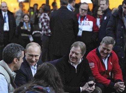 Russia's President Vladimir Putin (2nd L) sits next to to United States Olympic Committee (USOC) chairman Larry Probst (2nd R) as he visits Russia's President Vladimir Putin (2nd L) sits next to to United States Olympic Committee (USOC) chairman Larry Probst (2nd R) as he visits