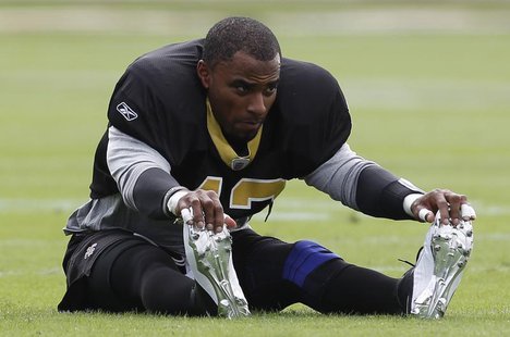New Orleans Saints safety Darren Sharper stretches before practice at the University of Miami practice facility in Coral Gables, Florida Feb New Orleans Saints safety Darren Sharper stretches before practice at the University of Miami practice facility in Coral Gables, Florida Feb