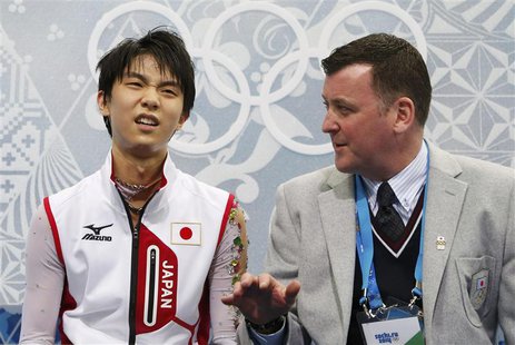 Japan's Yuzuru Hanyu reacts with coach Brian Orser in the "kiss and cry" area during the Figure Skating Men's Free Skating Program at the So Japan's Yuzuru Hanyu reacts with coach Brian Orser in the "kiss and cry" area during the Figure Skating Men's Free Skating Program at the So