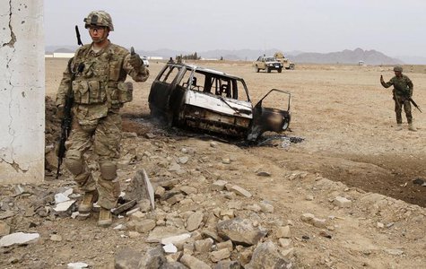 A U.S. soldier stands at the site of a suicide attack on a NATO base in Zhari, west of Kandahar province, January 20, 2014. REUTERS/Ahmad Na A U.S. soldier stands at the site of a suicide attack on a NATO base in Zhari, west of Kandahar province, January 20, 2014. REUTERS/Ahmad Na