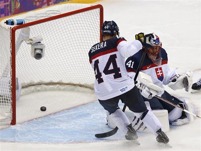 Slovakia's goalie Jaroslav Halak and teammate Andrej Sekera let in a goal by Slovenia's Rok Ticar, not seen, during the third period of thei Slovakia's goalie Jaroslav Halak and teammate Andrej Sekera let in a goal by Slovenia's Rok Ticar, not seen, during the third period of thei
