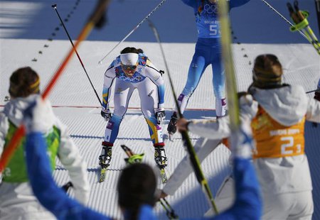 Sweden's Charlotte Kalla crosses the finish line to win the women's cross-country 4 x 5km relay event at the 2014 Sochi Winter Olympics Febr Sweden's Charlotte Kalla crosses the finish line to win the women's cross-country 4 x 5km relay event at the 2014 Sochi Winter Olympics Febr