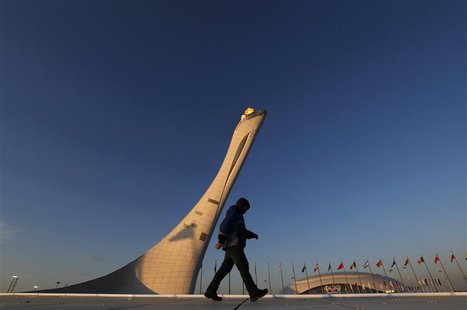 A workman walks on the cauldron at sunrise at the Olympic Park during the 2014 Sochi Winter Olympics, February 15, 2014. REUTERS/Gary Hersho A workman walks on the cauldron at sunrise at the Olympic Park during the 2014 Sochi Winter Olympics, February 15, 2014. REUTERS/Gary Hersho
