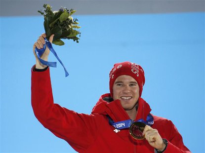 Gold medallist Switzerland's Dario Cologna poses during the victory ceremony for the men's cross-country 15km classic event at the 2014 Soch Gold medallist Switzerland's Dario Cologna poses during the victory ceremony for the men's cross-country 15km classic event at the 2014 Soch
