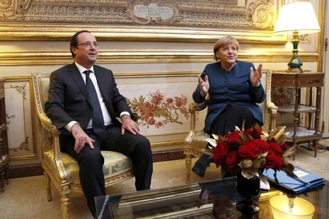 French President Francois Hollande and German Chancellor Angela Merkel (R) meet in President's office prior to a dinner at the Elysee Palace French President Francois Hollande and German Chancellor Angela Merkel (R) meet in President's office prior to a dinner at the Elysee Palace
