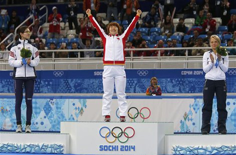 Second-placed South Korea's Shim Suk-hee (L), winner China's Zhou Yang (C), and third-placed Italy's Arianna Fontana celebrate during the fl Second-placed South Korea's Shim Suk-hee (L), winner China's Zhou Yang (C), and third-placed Italy's Arianna Fontana celebrate during the fl
