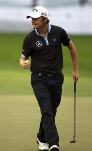Emiliano Grillo from Argentina pumps his fist after scoring an eagle on the 18th hole to briefly take the lead in the final round of the 201 Emiliano Grillo from Argentina pumps his fist after scoring an eagle on the 18th hole to briefly take the lead in the final round of the 201