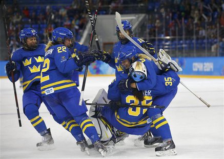Sweden's women's ice hockey players celebrate after defeating Finland in their women's ice hockey playoffs quarter-final game at the Sochi 2 Sweden's women's ice hockey players celebrate after defeating Finland in their women's ice hockey playoffs quarter-final game at the Sochi 2