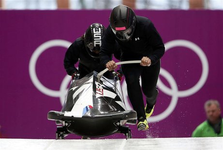 Pilot Elana Meyers (R) of the U.S. starts in a two-women bobsleigh training session at the Sanki Sliding Center in Rosa Khutor, during the S Pilot Elana Meyers (R) of the U.S. starts in a two-women bobsleigh training session at the Sanki Sliding Center in Rosa Khutor, during the S