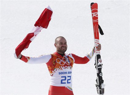 Canada's third-placed Jan Hudec celebrates with a flag during a flower ceremony after the men's alpine skiing Super-G competition during the Canada's third-placed Jan Hudec celebrates with a flag during a flower ceremony after the men's alpine skiing Super-G competition during the