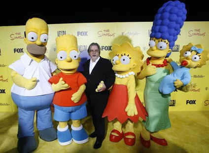 Matt Groening (C), creator of The Simpsons, poses with characters from the show (L-R) Homer, Bart, Lisa, Marge and Maggie at the 20th annive Matt Groening (C), creator of The Simpsons, poses with characters from the show (L-R) Homer, Bart, Lisa, Marge and Maggie at the 20th annive