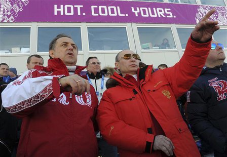 Russian President Vladimir Putin (C) and Sports Minister Vitali Mutko (L) watch the cross country skiing men's relay during the Sochi 2014 O Russian President Vladimir Putin (C) and Sports Minister Vitali Mutko (L) watch the cross country skiing men's relay during the Sochi 2014 O