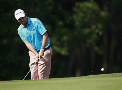 Thomas Aiken from South Africa chips a shot onto the 14th green during the first day of the HSBC Champions at Mission Hills in the southern Thomas Aiken from South Africa chips a shot onto the 14th green during the first day of the HSBC Champions at Mission Hills in the southern