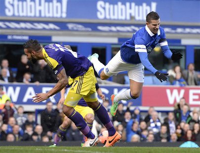 Everton's Kevin Mirallas (R) challenges Swansea's Kyle Bartley during their English FA Cup fifth round soccer match at Goodison park in Live Everton's Kevin Mirallas (R) challenges Swansea's Kyle Bartley during their English FA Cup fifth round soccer match at Goodison park in Live