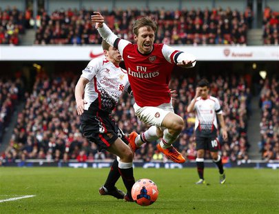 Arsenal's Nacho Monreal (R) is fouled by Liverpool's Jon Flanagan during their English FA Cup fifth round soccer match at the Emirates stadi Arsenal's Nacho Monreal (R) is fouled by Liverpool's Jon Flanagan during their English FA Cup fifth round soccer match at the Emirates stadi