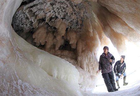 Sightseers look at ice formations in sea caves of the Apostle Islands National Lakeshore of Lake Superior near Cornucopia, Wisconsin Februar Sightseers look at ice formations in sea caves of the Apostle Islands National Lakeshore of Lake Superior near Cornucopia, Wisconsin Februar