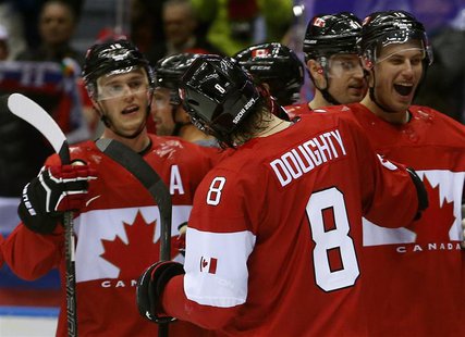 Canada's Drew Doughty (8) celebrates his game winning overtime goal against Finland with teammates during their men's preliminary round ice Canada's Drew Doughty (8) celebrates his game winning overtime goal against Finland with teammates during their men's preliminary round ice