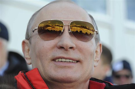 Russian President Vladimir Putin watches the cross country skiing men's relay during the Sochi 2014 Olympic Winter Olympics at Laura Cross-C Russian President Vladimir Putin watches the cross country skiing men's relay during the Sochi 2014 Olympic Winter Olympics at Laura Cross-C