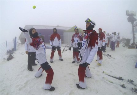 Canada's Christopher Robanske and compatriot Kevin Hill play with a tennis ball as they wait for the start of the men's snowboarding cross q Canada's Christopher Robanske and compatriot Kevin Hill play with a tennis ball as they wait for the start of the men's snowboarding cross q