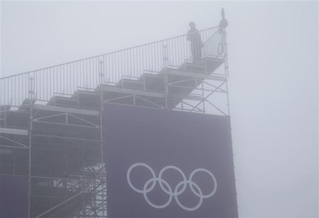 A person looks on from a spectator stand amidst fog during a delayed start for the men's snowboard cross competition at the 2014 Sochi Winte A person looks on from a spectator stand amidst fog during a delayed start for the men's snowboard cross competition at the 2014 Sochi Winte
