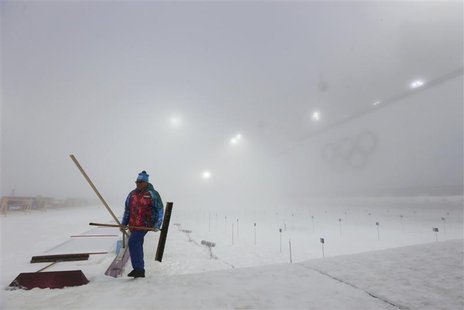 A worker walks past the track before the start of the men's biathlon 15km mass start event at the Sochi 2014 Winter Olympic Games in Rosa Kh A worker walks past the track before the start of the men's biathlon 15km mass start event at the Sochi 2014 Winter Olympic Games in Rosa Kh