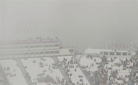 Spectators stand in the stands at the venue for the men's snowboard cross competition at the 2014 Sochi Winter Olympic Games in Rosa Khutor Spectators stand in the stands at the venue for the men's snowboard cross competition at the 2014 Sochi Winter Olympic Games in Rosa Khutor