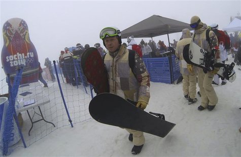 Snowboarders leave after the men's snowboard cross competition was cancelled due to fog at the 2014 Sochi Winter Olympic Games in Rosa Khuto Snowboarders leave after the men's snowboard cross competition was cancelled due to fog at the 2014 Sochi Winter Olympic Games in Rosa Khuto