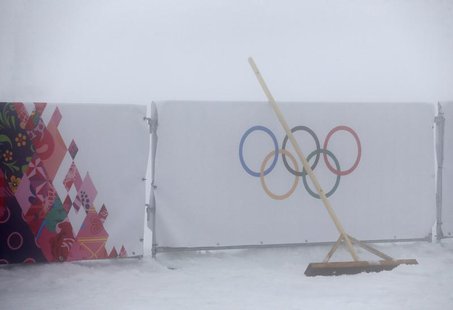 A broom is seen leant against a barrier bearing the Olympic rings as thick fog surrounds the Laura Cross Country Ski and Biathlon Center at A broom is seen leant against a barrier bearing the Olympic rings as thick fog surrounds the Laura Cross Country Ski and Biathlon Center at