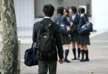A high school student (L) walks towards a group of female students chatting in front of a school in Tokyo November 9, 2006. REUTERS/Kiyoshi A high school student (L) walks towards a group of female students chatting in front of a school in Tokyo November 9, 2006. REUTERS/Kiyoshi