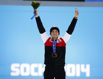 Gold medallist Alex Bilodeau of Canada poses during the medals ceremony for the men's freestyle skiing moguls competition at the 2014 Sochi Gold medallist Alex Bilodeau of Canada poses during the medals ceremony for the men's freestyle skiing moguls competition at the 2014 Sochi
