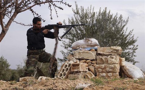 A Free Syrian Army fighter takes a position as he fires his weapon during clashes with forces loyal to Syria's President Bashar al-Assad in A Free Syrian Army fighter takes a position as he fires his weapon during clashes with forces loyal to Syria's President Bashar al-Assad in