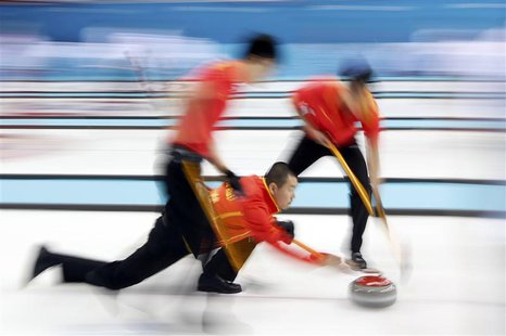 China's skip Liu Rui (C) delivers a shot during their men's curling round robin game against Britain at the Ice Cube Curling Center during t China's skip Liu Rui (C) delivers a shot during their men's curling round robin game against Britain at the Ice Cube Curling Center during t