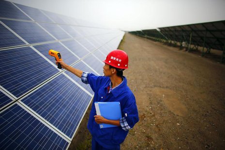 A worker inspects solar panels at a solar farm in Dunhuang, 950km (590 miles) northwest of Lanzhou, Gansu Province September 16, 2013. REUTE A worker inspects solar panels at a solar farm in Dunhuang, 950km (590 miles) northwest of Lanzhou, Gansu Province September 16, 2013. REUTE