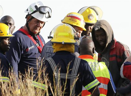 A suspected illegal miner talks to officials after being rescued from an abandoned gold shaft in Benoni, east of Johannesburg, February 16, A suspected illegal miner talks to officials after being rescued from an abandoned gold shaft in Benoni, east of Johannesburg, February 16,