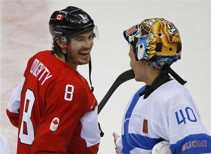 Canada's Drew Doughty laughs with Finland's goalie Tuukka Rask after Canada defeated Finland in overtime in their men's preliminary round ic Canada's Drew Doughty laughs with Finland's goalie Tuukka Rask after Canada defeated Finland in overtime in their men's preliminary round ic