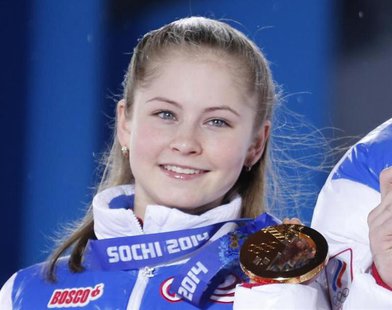 Yulia Lipnitskaya of the gold medal-winning Russian figure skating team poses with her medal during the medal ceremony for the figure skatin Yulia Lipnitskaya of the gold medal-winning Russian figure skating team poses with her medal during the medal ceremony for the figure skatin