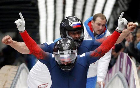 Russia's pilot Alexander Zubkov and Alexey Voevoda gesture after completing the final run of the men's two-man bobsleigh competition at the Russia's pilot Alexander Zubkov and Alexey Voevoda gesture after completing the final run of the men's two-man bobsleigh competition at the
